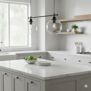 Pair of clear glass globe farmhouse pendant lights highlighting a minimalist kitchen island setup.