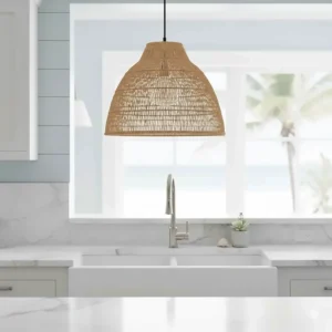 A woven rattan pendant light adding texture to a coastal style kitchen sink area.