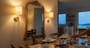 Elegant fabric-shaded battery operated wall sconces framing a large dining room mirror to create soft accent lighting.