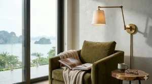 An adjustable swing-arm wall sconce installed in a cozy living room reading nook next to an armchair.