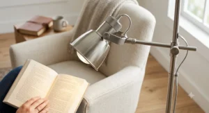 Close-up of a brushed nickel reading floor lamp showing the adjustable pivoting head directing light downward for reading.