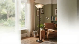 An uplighter torchiere lamp featuring an adjustable side reading light next to a plush sofa.