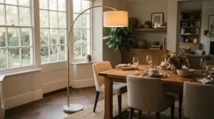 A brushed brass dimmable torchiere floor lamp adding elegance to a transitional dining space