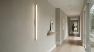 Minimalist modern torchiere floor lamp brightening a wide hallway entrance