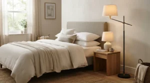 Sleek torchiere lamp for corner bedroom use providing gentle upward illumination.