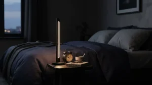 A modern bedside table lamp for small nightstand with a matte black finish and tiny footprint.
