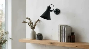 A bold modern bedside table lamp for master bedroom with a matte black finish against light walls.